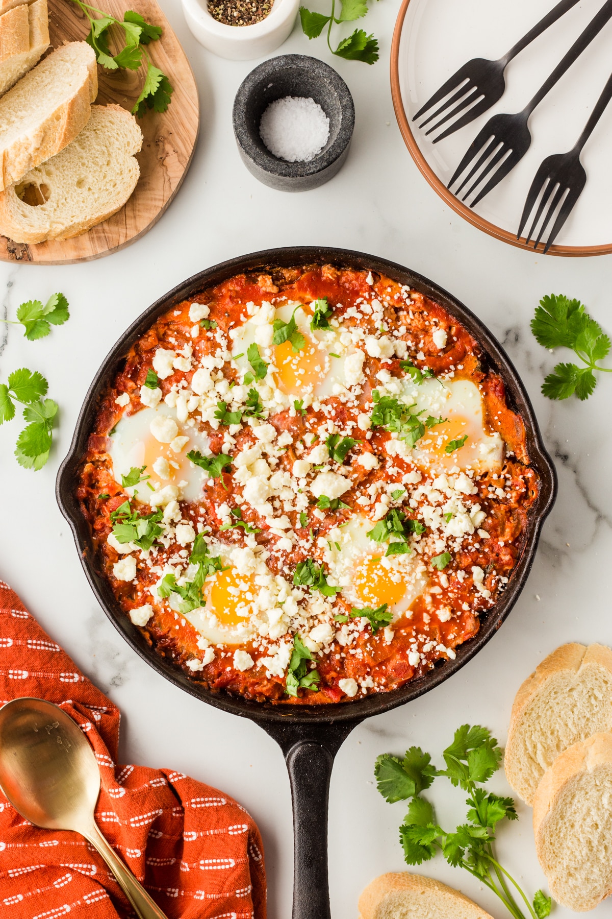 Finished shakshuka, shot overhead in a cast iron pan. 