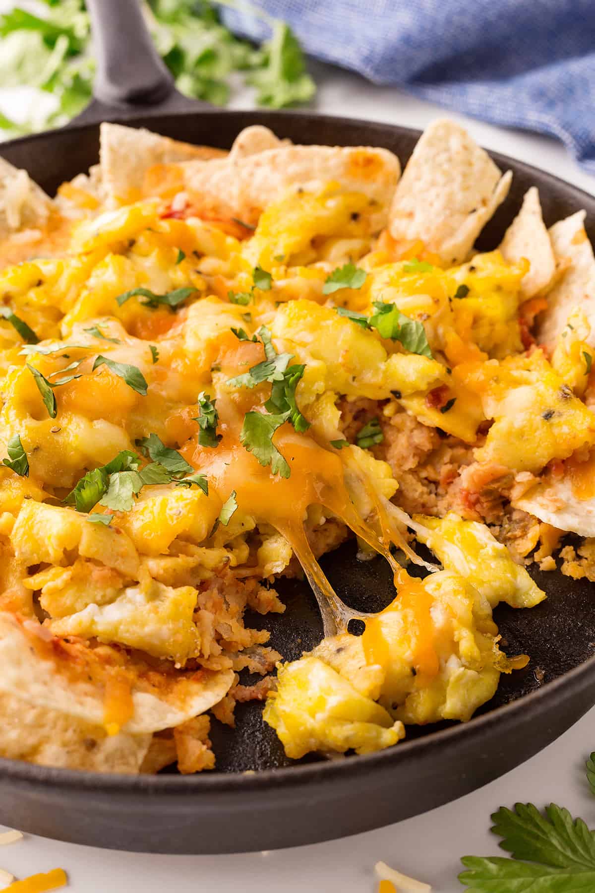 Chilaquiles with scrambled eggs in a cast iron skillet. 