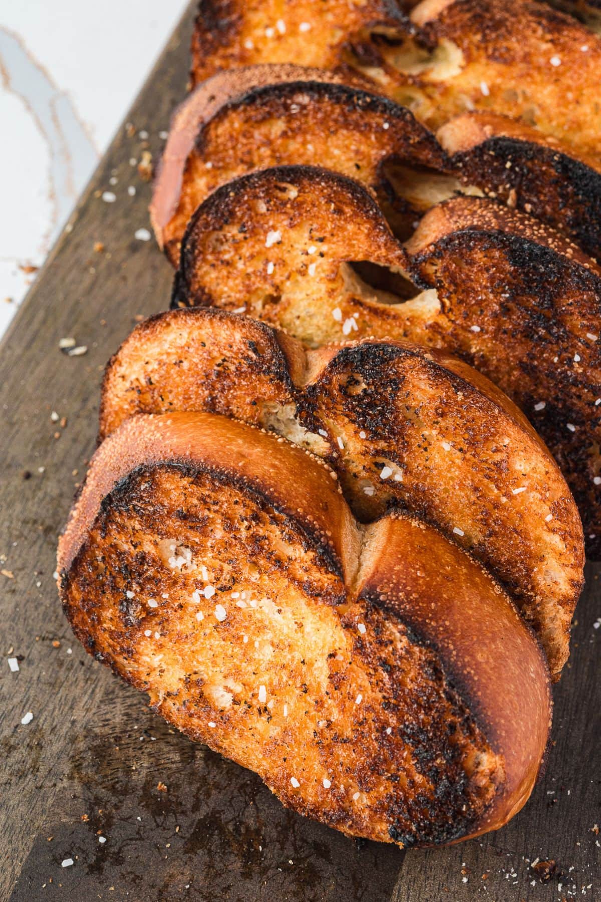 Grilled garlic bread on a cutting board.